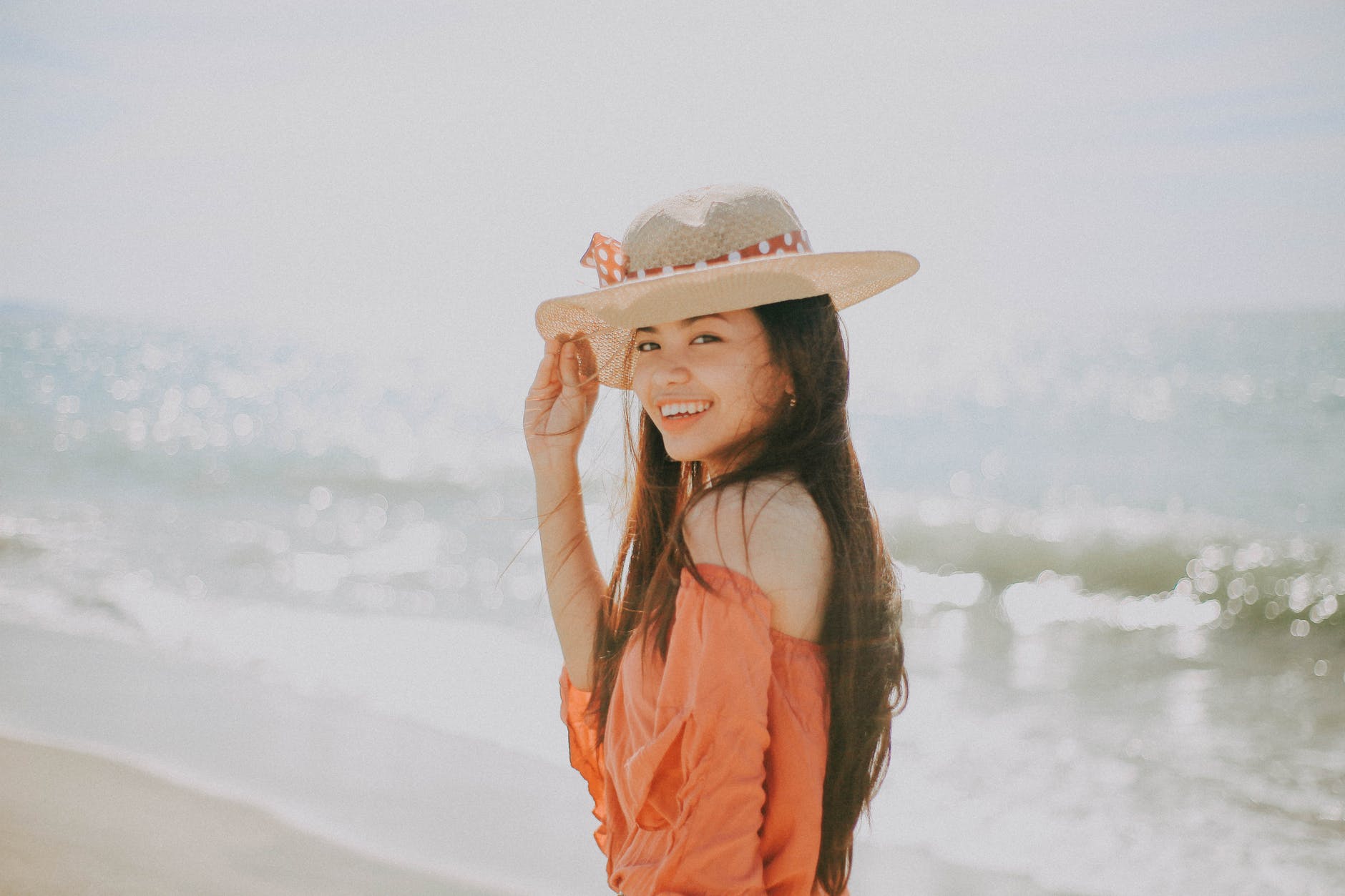 selective focus photography of smiling girl near beach
